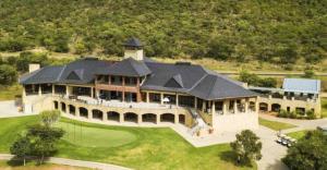 an aerial view of a large house with a golf course at Missie Villa 165 on Rooibok Euphoria Golf in Naboomspruit