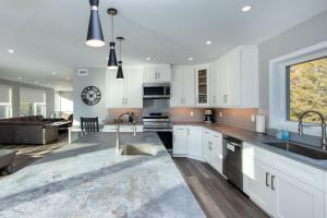 a kitchen with white cabinets and a living room at 107 Birchview Trail in Blue Mountains