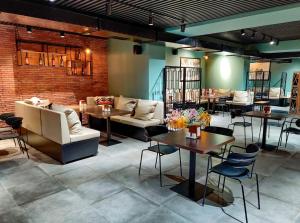 a restaurant with tables and couches in a room at Crystal Loft Apartment 212 in Bakuriani