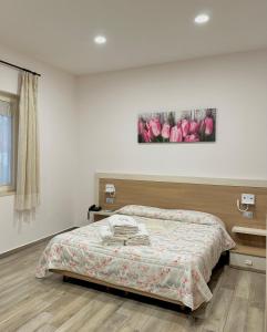 a bedroom with a bed and a painting on the wall at Villa Magiola Pompei in Pompei