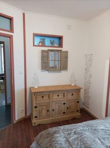 1 dormitorio con armario de madera y ventana en Marguerite, en Bussang