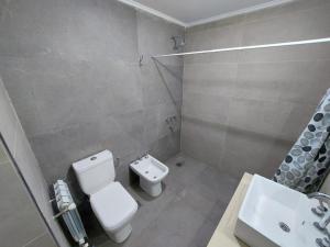 a bathroom with a toilet and a sink at Monte Hermoso del Este-Punta Tejada in Monte Hermoso