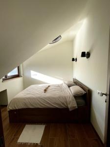 a bedroom with a bed in a attic at Golden Gondola Tornik in Zlatibor