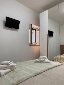 a bedroom with a bed with a mirror and a television at Al Larghetto in Lamezia Terme