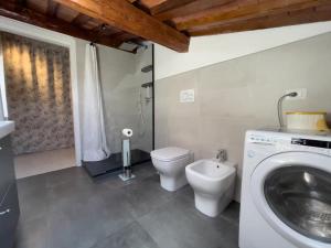 a bathroom with a toilet and a sink and a washing machine at The Perfect Base to Explore Tuscany - Between Pisa, Lucca, and Florence! - Netflix & YouTube Premium Included in Montecatini Terme