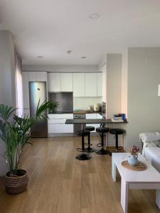 a kitchen and living room with a table and chairs at CALLE MARINA in Huelva