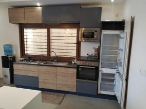 a kitchen with a refrigerator and a stove top oven at Villa Fayenne in Sali Tapé