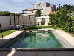 a swimming pool in the backyard of a house at Villa Fayenne in Sali Tapé