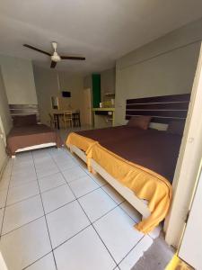 a bedroom with two beds and a tiled floor at Labrish Guest House in Kingston