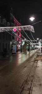 an empty street with christmas lights on a city at night at Zielona Przystań in Łódź