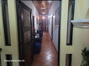 a corridor of a building with chairs and a hallway at LA CAPITANÍA RURAL, SAN PEDRO in Antigua Guatemala