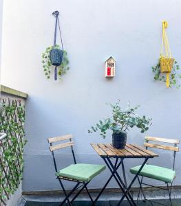 a table and two chairs next to a white wall at Stunning Brighton Seaside 2-Bedroom Townhouse with Patio, Sleeps 6 in Brighton & Hove