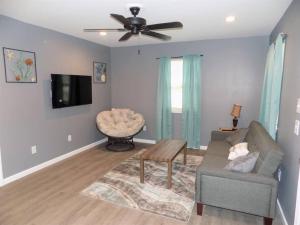 a living room with a couch and a ceiling fan at Fishing Retreat C in Pensacola