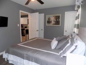 a bedroom with a large bed with pillows on it at Fishing Retreat C in Pensacola