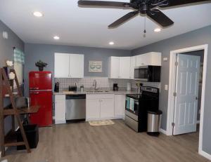 a kitchen with white cabinets and a red refrigerator at Fishing Retreat C in Pensacola