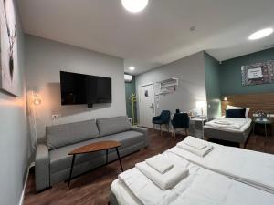 a hotel room with a bed and a couch at Stay Vilnius Hotel in Vilnius
