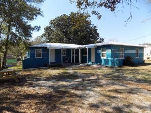 a blue house with a picnic table in front of it at Fishing Retreat C in Pensacola