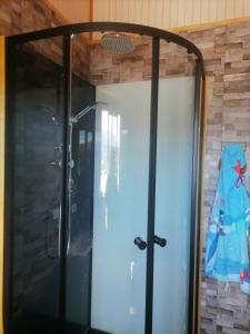 una puerta a una ducha en una habitación en herencia de pioneros, en Coyhaique