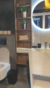 W łazience znajduje się biała toaleta i lustro. w obiekcie Appartement sur Marrakech w Marakeszu