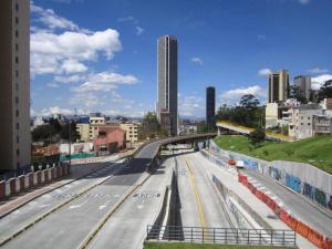 an empty highway in a city with buildings at Spacio30 in Bogotá