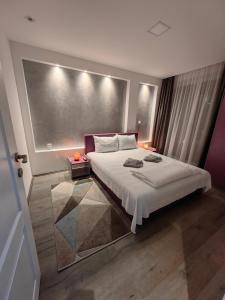 a bedroom with a large bed in a room at Apartmani MiS apartman br 2 in Soko Banja