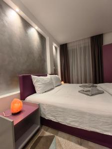 a hotel room with two beds and a table at Apartmani MiS apartman br 2 in Soko Banja