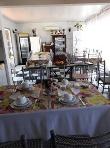 a dining room with a table with dishes on it at Hotel Bella Unión in Bella Unión