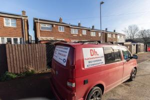 a red van with a sign on the side of it at Dwellcome Home Ltd 3 Bedroom Sunderland House - see our site for assurance in Pallion