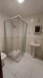 a bathroom with a shower and a sink at Apart Angra dos Reis I in Angra dos Reis