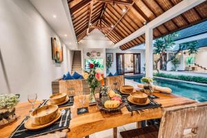 a dining room with a table and a pool at Villa Olli with Private Pool in the Heart of Seminyak - Free WI-FI and Netflix in Seminyak