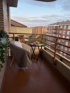 a balcony with a table and a view of buildings at APARTAMENTO SARDINERO - CÉNTRICO RH SANTANDER in Santander