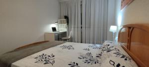 a bedroom with a bed and a desk in a room at APARTAMENTO SARDINERO - CÉNTRICO RH SANTANDER in Santander