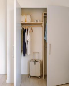 a walk in closet with a suitcase in it at Sonder Battery Park in New York