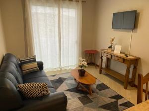 a living room with a couch and a table at Apart Angra dos Reis I in Angra dos Reis