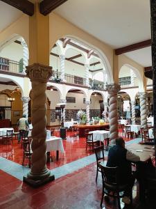 a person sitting at a table in a restaurant at HOTEL VIRREYNAL in Teziutlán