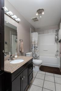 a bathroom with a sink and a toilet and a tub at Raven in Valemount