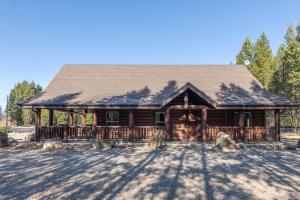 a log cabin with a gambrel roof at Raven in Valemount