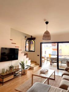 a living room with a couch and a table at Meloneras by the sea in San Bartolomé de Tirajana