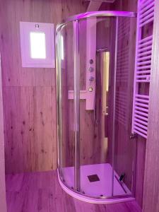 a bathroom with a shower with a purple lighting at La Cementina sul mare in Bari