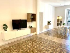 a living room with a flat screen tv on a wall at La Cementina sul mare in Bari