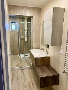 a bathroom with a sink and a shower at La Cementina sul mare in Bari