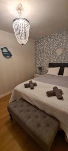 a bedroom with a large bed with a chandelier at Old town - Beach apartment in Benidorm