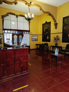 a large room with yellow walls and a table and chairs at HOTEL VIRREYNAL in Teziutlán
