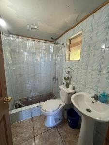 a bathroom with a toilet and a sink at Hostel del Valle in Recinto