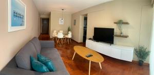 a living room with a couch and a tv at MLA apartments - Kennedy in Lima