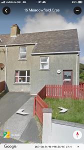 a rendering of a house with a red fence at Cosy flat, Scalloway in Scalloway