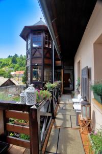 a porch of a house with a building at Penzion Veza in Kremnica