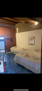 a bedroom with two beds in a room at Pousada Ibirapuera in Jericoacoara