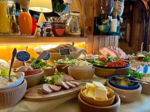 a buffet of food on a table with bowls of food at Marina Zakopane in Zakopane