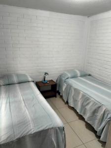 Postel nebo postele na pokoji v ubytování Hotel Angamos